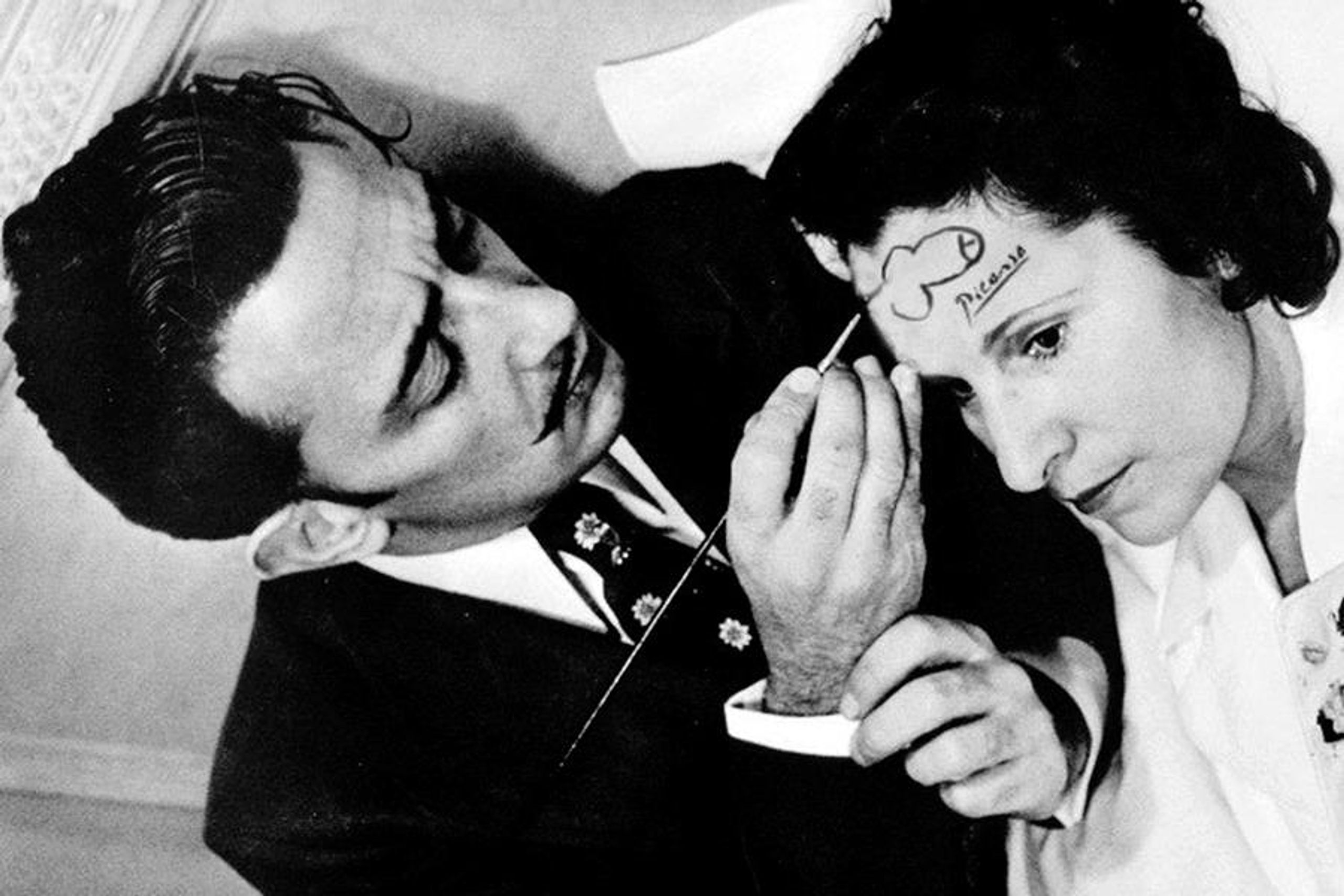 Dali drawing a dick on a woman's forehead.
